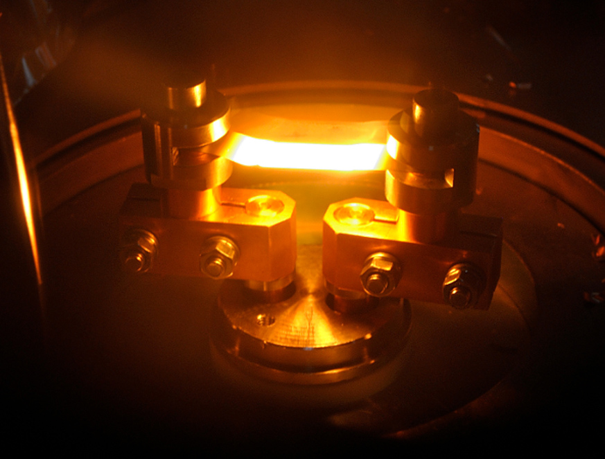 The tungsten boat heating up, to melt and then evaporate the gold, looked similar to this. The tungsten boat heating up, to melt and then evaporate the gold, looked similar to this.